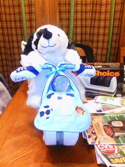 Diaper cakes are a stack of rolled or folded diapers made to look like a traditional tiered cake. Make a Motorcycle Diaper Cake | Diaper motorcycle cake ...