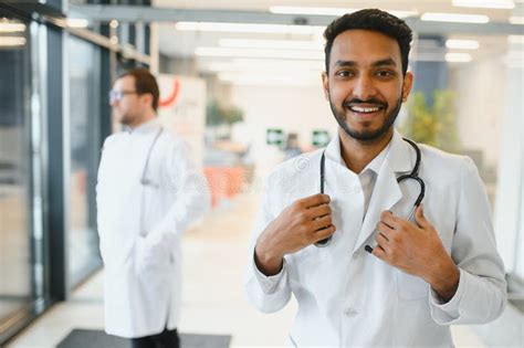 Portrait Of A Asian Indian Male Medical Doctor In Uniform Stock Photo