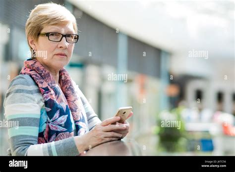 Elegant Mature Woman Uses Smartphone Internet And Social Networks