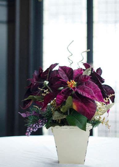 White wedding flowers embody purity, innocence, and romance. Purple Poinsettia Centerpiece | Winter wedding ...