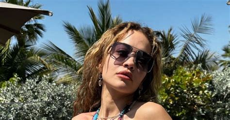 rita ora showcases washboard abs as she tugs up top in string bikini for racy snaps daily star