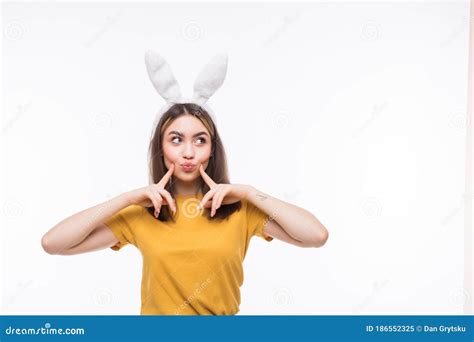 Beautiful Young Woman Wearing Cute Bunny Ears And Holding Her Head In