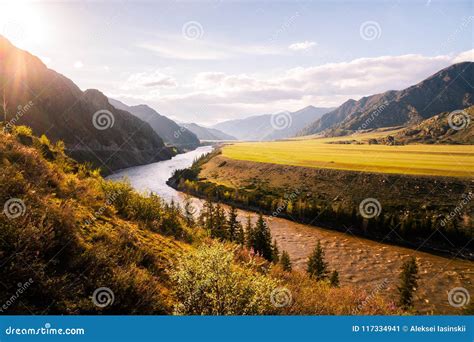 Incredible Landscape Of Altai Mountain Valley With River At Sunset