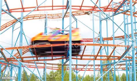 Colorful Amusement Park Ride Car Going Fast By With Full Speed People Having Fun In Theme Park