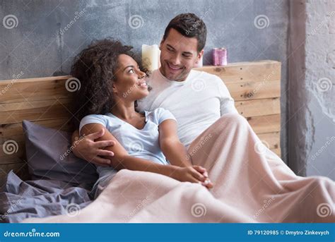 happy couple chilling out in the bed together stock image image of delighted married 79120985