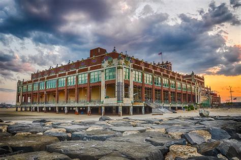 In the entrance to the beach.in the background people on the beach with umbrellas. Asbury Park Photograph by Kristopher Schoenleber