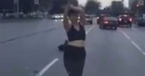 Bizarre Moment Woman Strips In Middle Of Road And Dances For Cars In