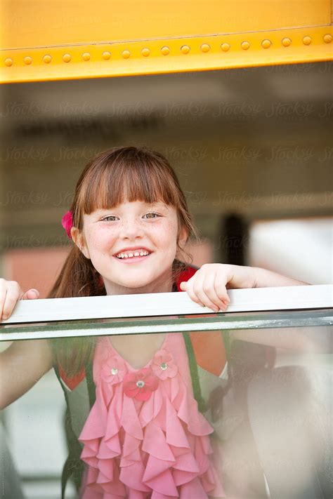 School Bus Cute Girl Looks At Camera By Stocksy Contributor Sean