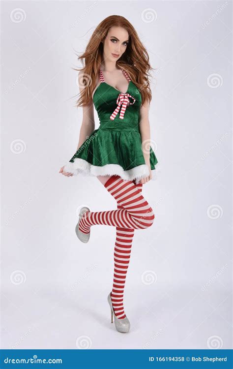 Beautiful Tall Slim Busty Redhead Model Dressed As A Sexy Elf Royalty Free Stock Image