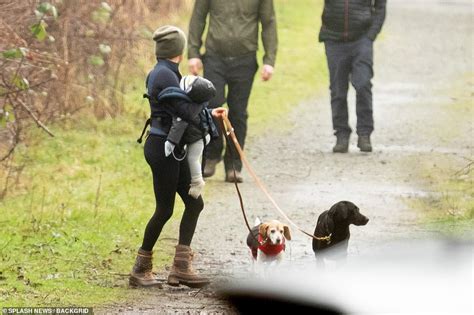 Can't blame prince charles for. Meghan beams while carrying Archie and walking dogs in ...