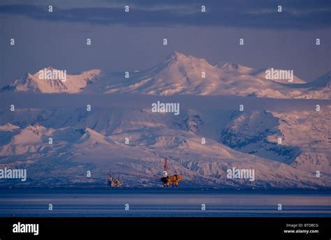 Three Drill Rigs In Cook Inlet With Mt Spurr Looming Large In The