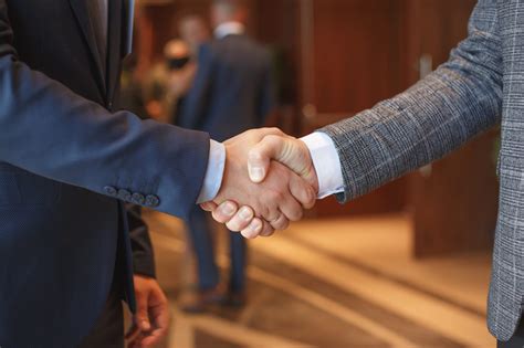 Men Shake Hands At Business Meeting The Swiss Quality Consulting