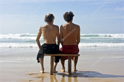 Two Men Gazing At A Wild Ocean In Summertime Stock Photo By Nilaya