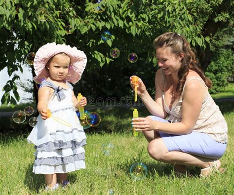 Beautiful Mother And Daughter Blow Bubbles Stock Photo Image Of