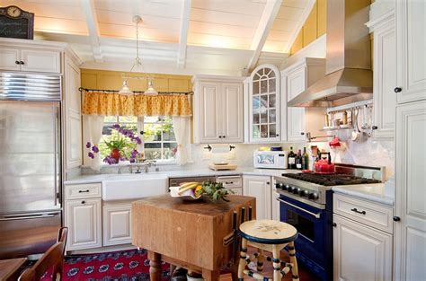 A small kitchen island in black with a white countertop and a sink plus a space for one to have meals. 24 Tiny Island Ideas for the Smart Modern Kitchen
