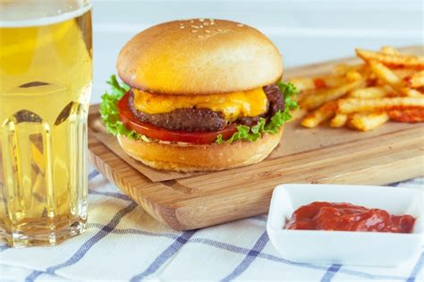 Premium Photo Burger And French Fries On Wooden Table