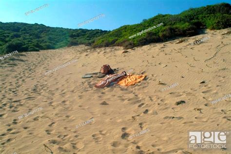 Naked Woman Lying At Sandy Beach Spain Balearen Majorca Stock Photo