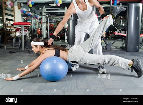 Indian Sports Trainer And Lady Gym Exercising Stock Photo Alamy
