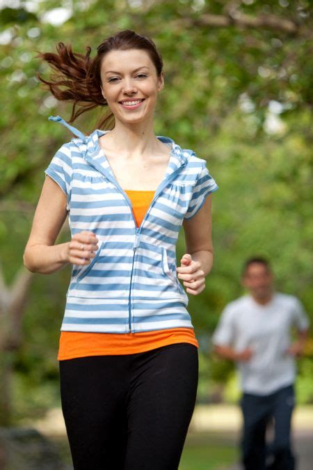 Athletic Woman Running At The Park Smiling Freestock Photos
