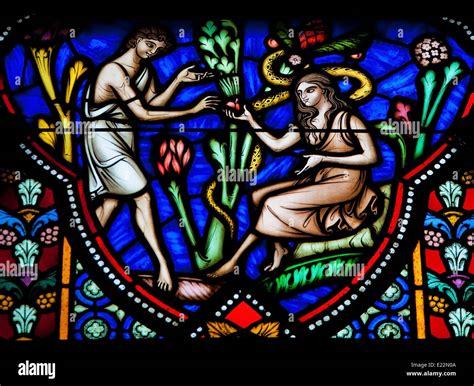 Adam And Eve Eating The Forbidden Fruit In The Garden Of Eden On A Stained Glass Window In The