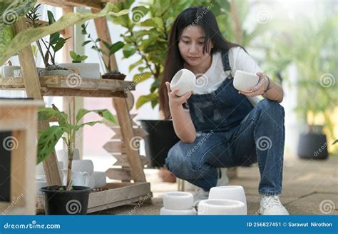 Young Woman Caring For Trees Planting And Caring Equipment Plants In