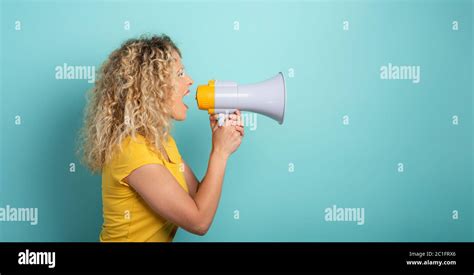 Woman Screams With Loudspeaker Angry Expression Cyan Background Stock