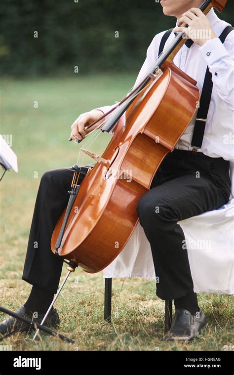 Young Man Playing Cello Outside Cellist Playing Classical Music On