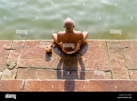 a pilgrim is praying meditating at the holy river ganges at dashashwamedh ghat main ghat in