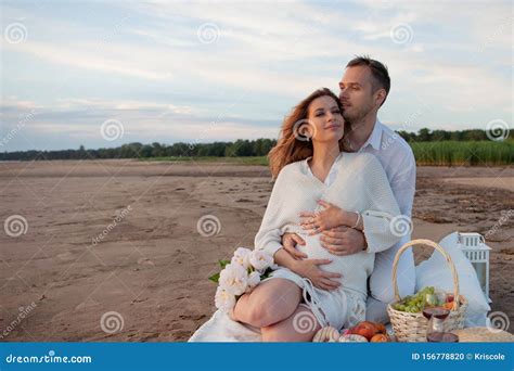Picnic Love Tenderness The Couple Sits On A Plaid A Man Embraces Pregnant Woman With His