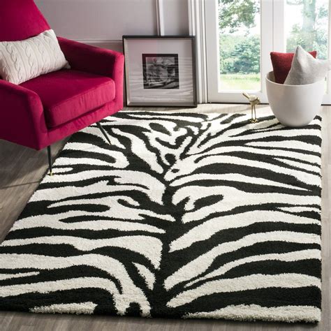 A Black And White Zebra Print Rug In Front Of A Red Chair With Two Pillows