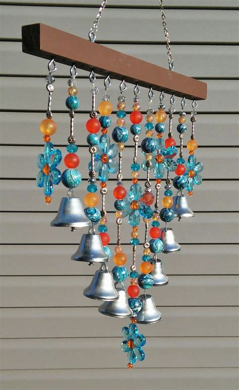 An Image Of A Wind Chime Hanging From A Wooden Beam With Bells And Beads