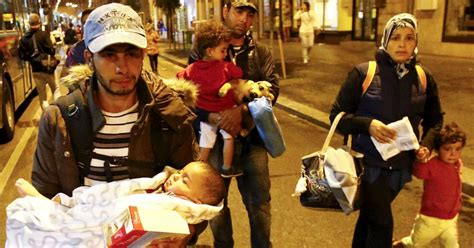 Refugees Arrive In Austria From Hungary As Desperate Migrant Families Board Buses To Border