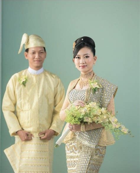 A Man And Woman Standing Next To Each Other In Formal Wear With Flowers On Their Bouquets