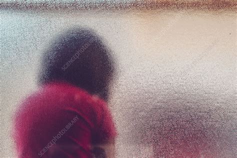 Silhouette Of Sad Girl Behind Frosted Glass Stock Image