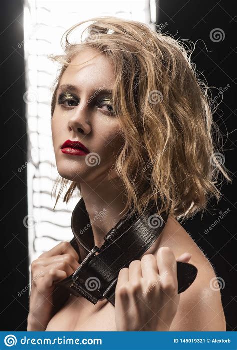 conceptual portrait of a blonde girl with disheveled wet hair oily skin aggressive make up
