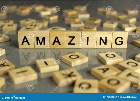 Word Amazing Is Made Of Square Wooden Letters On A Gray Background