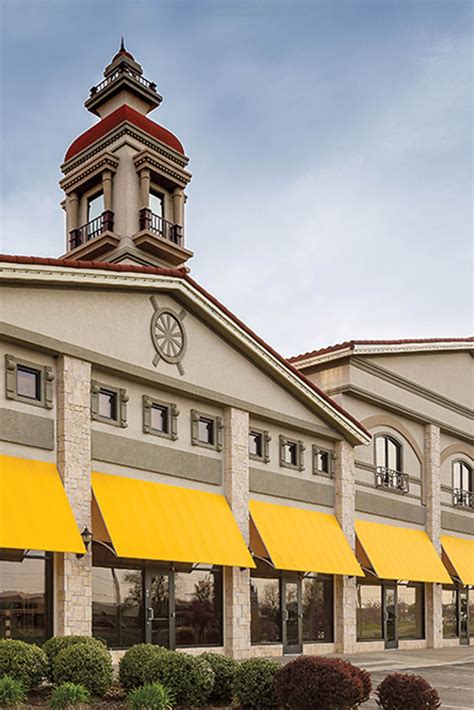 Join our happy customers today! Storefront Adorned with Yellow Awnings | Fabric awning ...