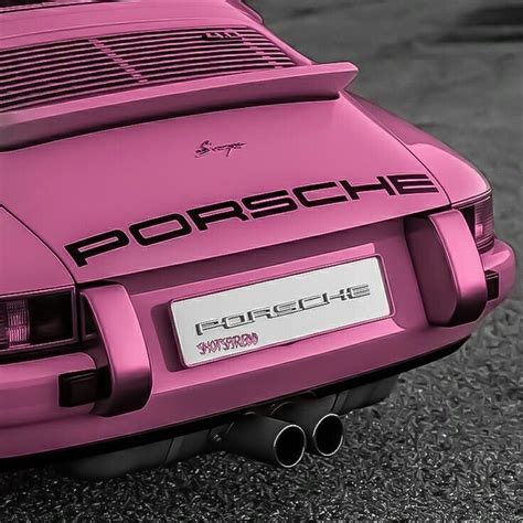 A Pink Porsche Sports Car Parked In A Parking Lot