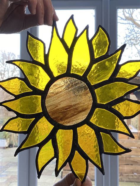 The round piece of stained glass was built specifically for this frame and installed into the antique porthole. Sunflower in 2020 | Stained glass window hanging, Stained ...