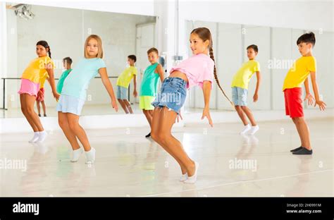 Kids Warming Up In Group Dance Class Doing Stretching Exercises Before