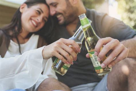 Young Couple Sitting In Park And Holding Bottle Of Drink Stock Image Image Of Couple Focus
