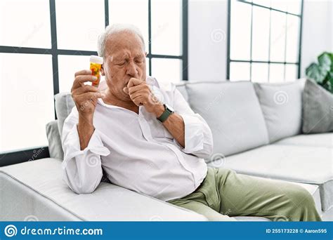Senior Man Holding Pills Feeling Unwell And Coughing As Symptom For