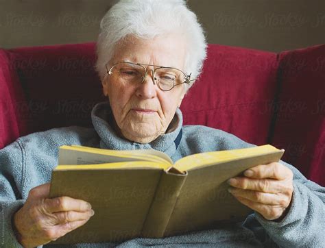 Older Woman Holding Book Reading With Homemade Eyeglasses Del