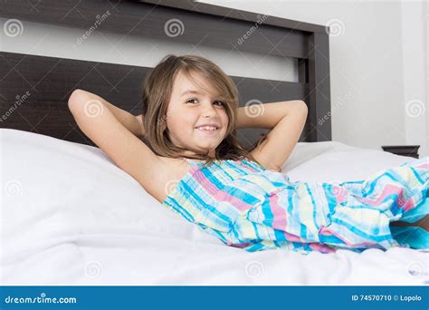 Portrait Of Beautiful Little Girl Lying On Bed Stock Photo Image Of