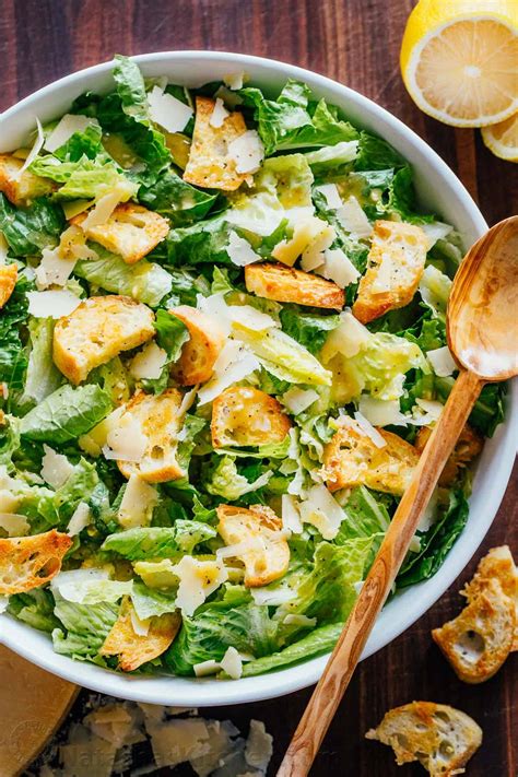 Chopped romaine lettuce and garlicky croutons, tossed in a creamy dressing made with eggs, olive oil, lemon, parmesan, worcestershire sauce, and anchovies. Caesar Salad Recipe - NatashasKitchen.com