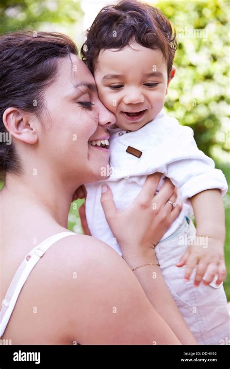 Mother Cuddling Her Baby Boy Smiling Stock Photo Alamy