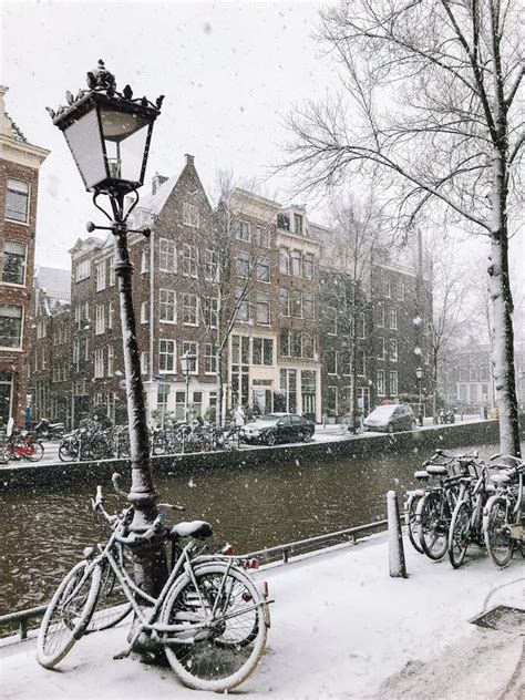 Snowy Bicycles On The Bridge In The City Center From Amsterdam Stock