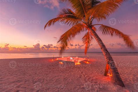 Romantic Dinner On The Beach With Sunset Candles With Palm Leaves And