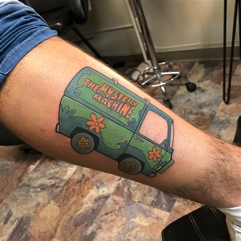A Man With A Green Van Tattoo On His Arm