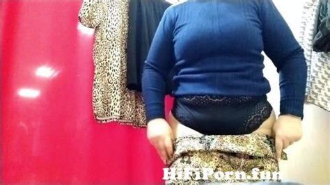 Curvy Lady Trying On Clothes In A Shopping Mall Fitting Room From